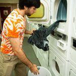 student doing laundry