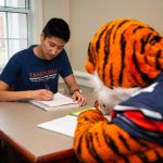 student studying with Aubie
