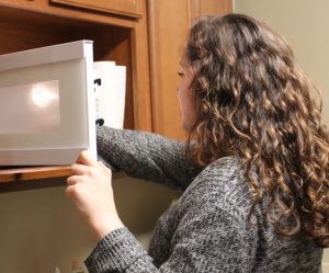 student using microwave
